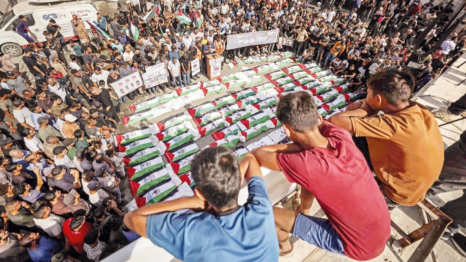 Gaza holds funeral for 100 Palestinians recovered from rubble of destroyed homes