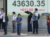 Asian stocks extend gains but US concerns hit dollar, boost gold
