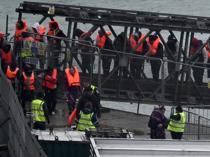 UK says first migrants held under return deal with France