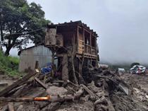 Indian rescuers scour debris after 60 killed in flood