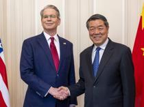 Trump says he could delay Beijing trip as delegations meet