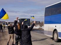 Ukrainians greet POWs with tears and cheers