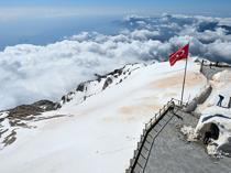 Snowy summit of Tahtalı Mountain attracts visitors in spring