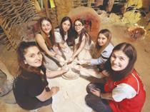 Students put away their phones to experience life 8,200 years ago