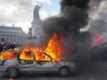Protests banned in parts of Paris as Macron swipes at Trump