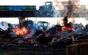 Macron meets French farmers in bid to defuse anger over trade deal