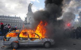 Protests banned in parts of Paris as Macron swipes at Trump