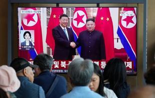 Chinas Xi lands in North Korea for rare visit