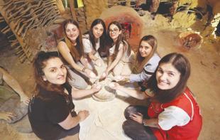 Students put away their phones to experience life 8,200 years ago