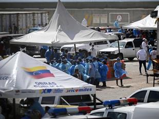Key Venezuela port opens with US aid, as burials begin