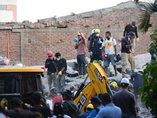 Woman pulled alive from Colombia quake rubble as toll rises