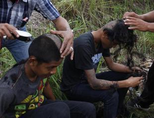 Hard-line Indonesian police shave punkers mohawks