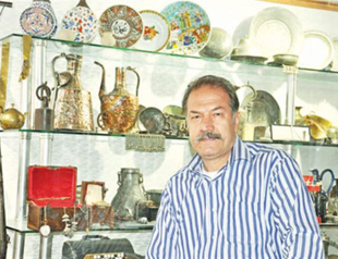 Businessman presents antiques in his museum