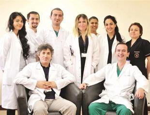 Transplant patient touches his son with both hands