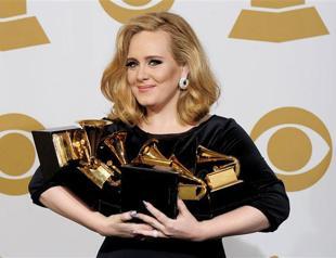 Adele triumphs at Grammys, clouded by Houston death