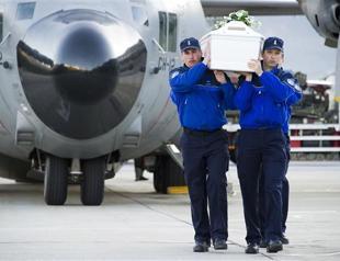 Plane with bodies of crash victims lands in Belgium