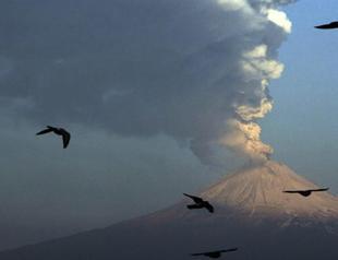 Mexico volcano spews glowing rock, tower of ash