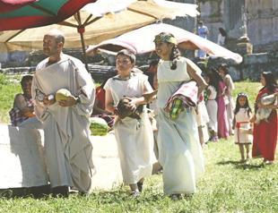 People exchange products in Roman Bazaar at ancient city