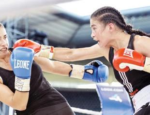 Women boxers hold the flag for equality