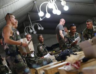NATO troops watch Games with weapons at hand