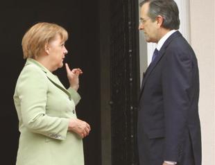 Merkel encourages Greece amid protests