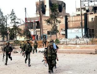 Syria sends extra troops after rebels seize key town: NGO