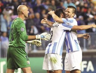 Brave Malaga rides out storm in style