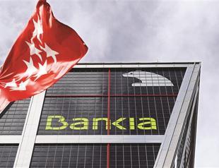 EU clears restructuring of four debt-hit Spanish banks