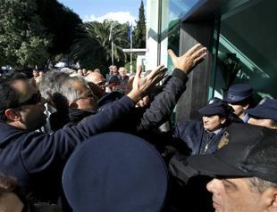 Angry bank clients push way into Greek Cyprus parliament