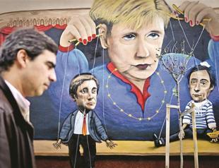 Merkel defends austerity on Portugal battleground