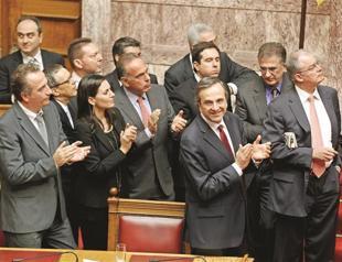 Greece OKs bitter 2013 budget to access new lifeline