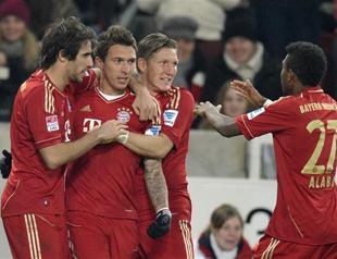 Bayern win in Stuttgart to extend lead, set record