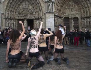 Topless women fete popes resignation in Paris cathedral