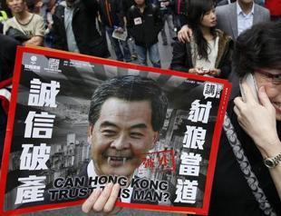 Tens of thousands march against Hong Kong leader