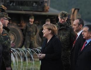Merkel launches busy trip at site of Patriots