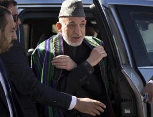 Afghanistans Karzai heads to Qatar to discuss peace with Taliban