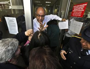 Greek Cyprus banks reopen with limits on transactions