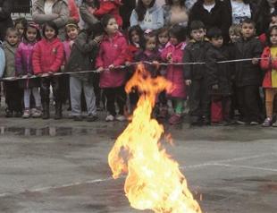 Firemen put burining gas cylinder on fire near kids