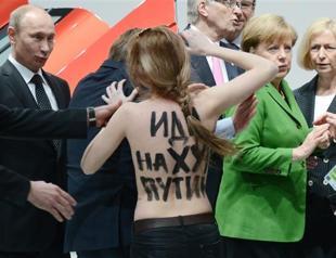 Topless protest as Putin clashes with Merkel on rights