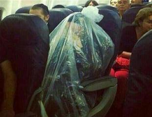 Orthodox Jew covers self with plastic bag while flying over cemetery