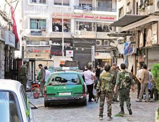 Twin suicide blasts kill at least 14 in central Damascus