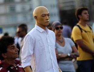 Hundreds stand in silence imitating the standing man