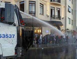 Police intervene with water cannons against protesters gathered at Taksim Square