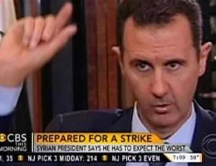 Assad warns US will pay the price if it attacks Syria