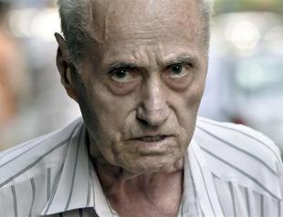 Ex prison guard charged with genocide