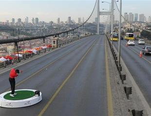 Woods hits balls from Asia to Europe on Istanbuls Bosphorus Bridge