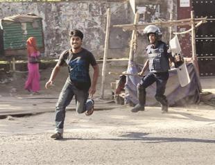 Bangladesh police fire tear gas in clash over wage rise