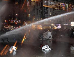 Police fire water cannon at group gathered to commemorate slain student in Taksim