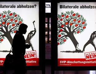 EU to review Swiss ties after vote curbing immigration