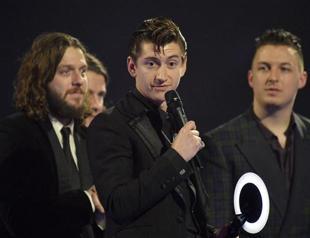 Bowie becomes oldest Brit winner, but Arctic Monkeys steal show